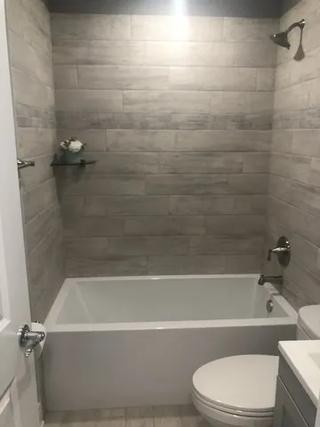 a bathroom with a bathtub and a toilet
