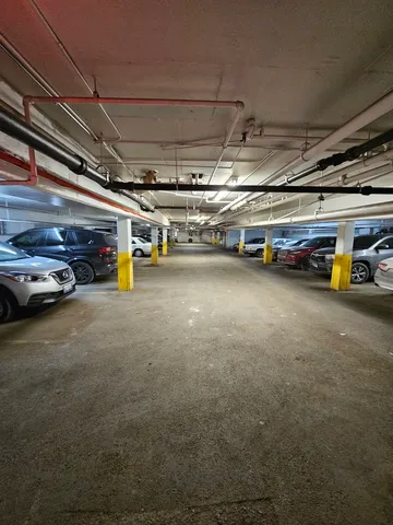a view of parking garage with cars
