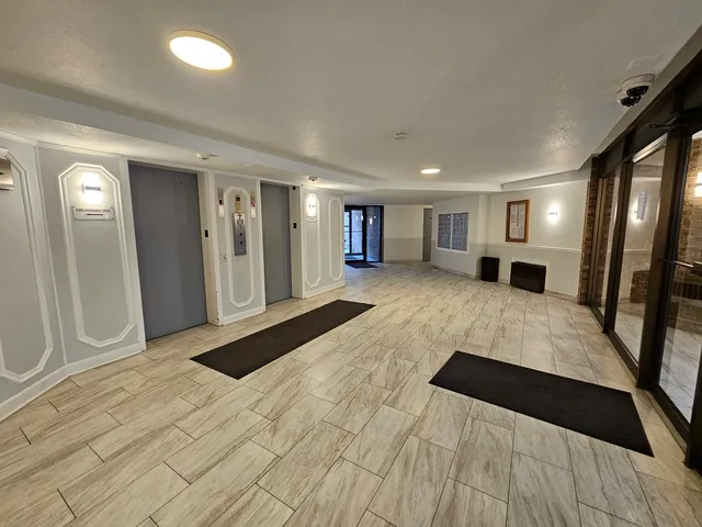 a large bedroom with a bed and a mirror