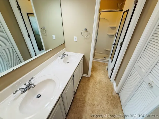 a bathroom with a tub a sink and a mirror
