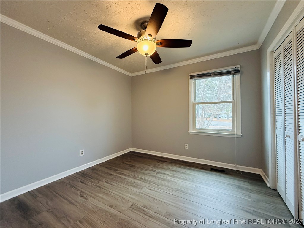 5901 Rehoboth Road Hope Mills, NC 28348 - Photo 16 of 22 an empty room with wooden floor and windows