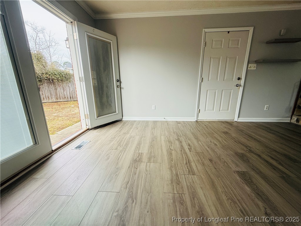 5901 Rehoboth Road Hope Mills, NC 28348 - Photo 5 of 22 a view of an empty room with wooden floor and a window