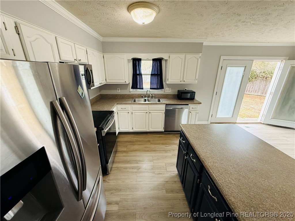 5901 Rehoboth Road Hope Mills, NC 28348 - Photo 8 of 22 a kitchen with stainless steel appliances granite countertop a sink stove and refrigerator