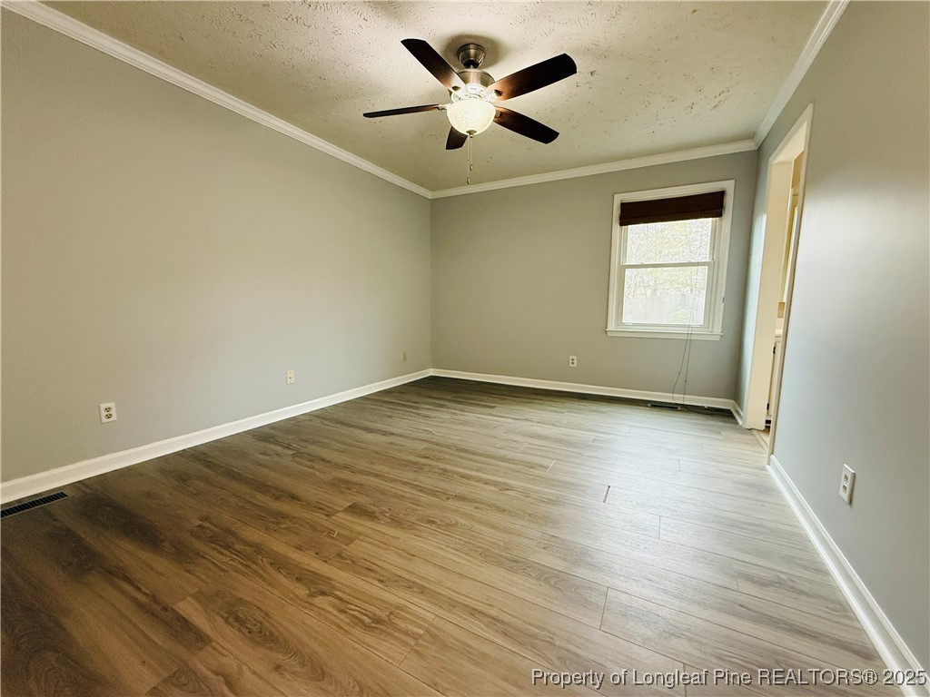 5901 Rehoboth Road Hope Mills, NC 28348 - Photo 10 of 22 an empty room with wooden floor and windows