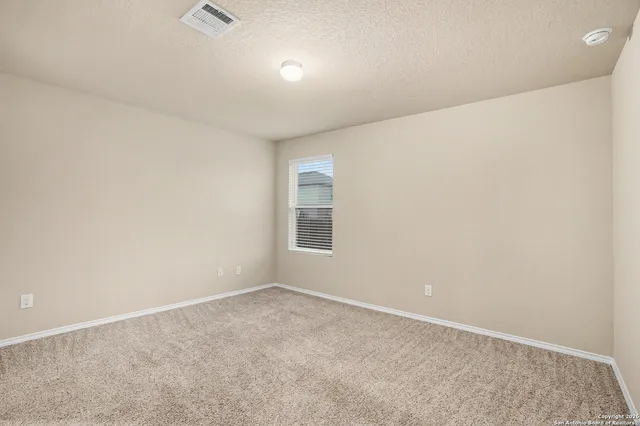 an empty room with a empty space and windows