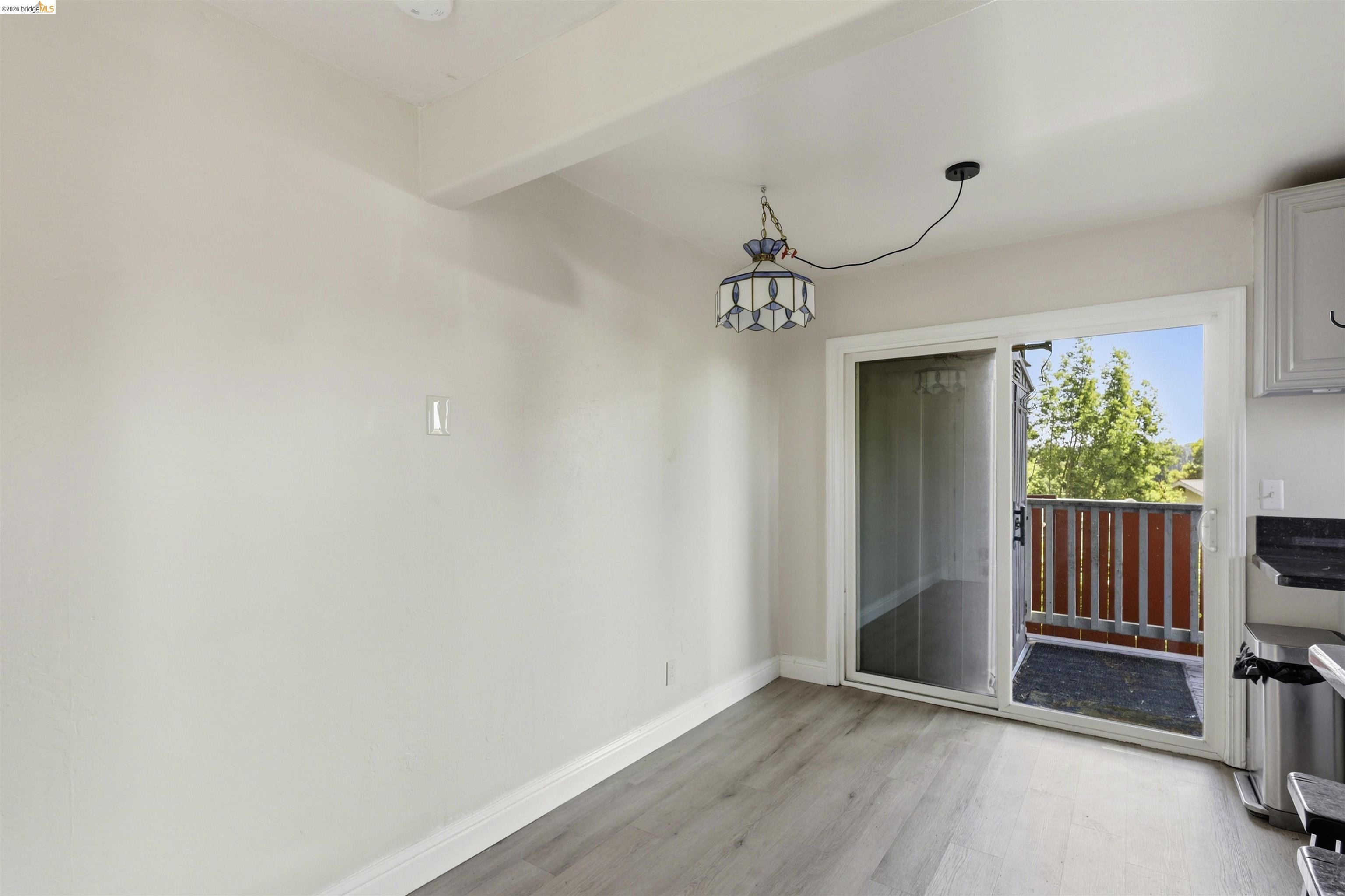 7555 Sunset Way, Unit 6 Aptos, CA 95003 - Photo 19 of 37 Dining area featuring wood-finish flooring and a sliding glass door opening to a private balcony with wood railing