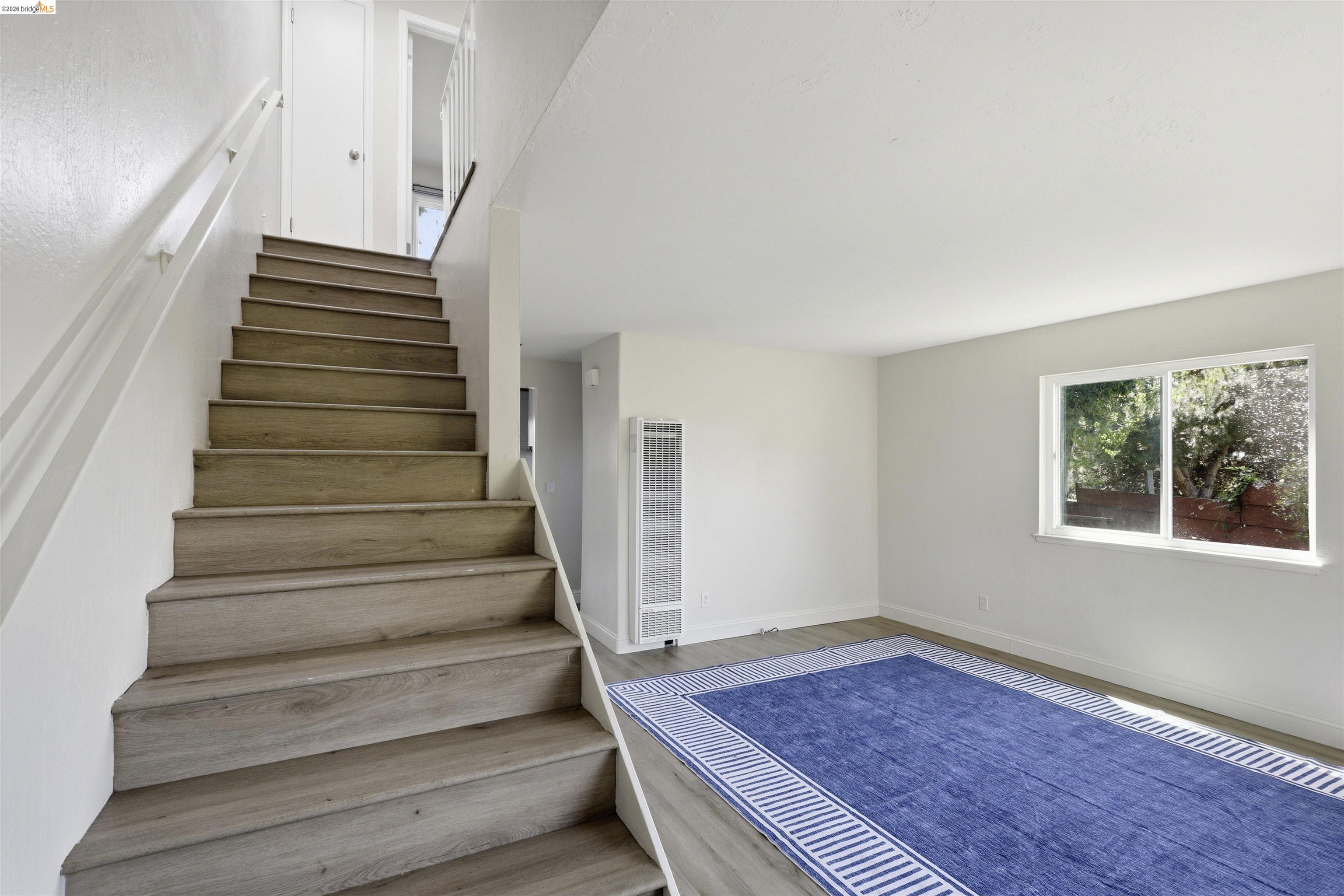 7555 Sunset Way, Unit 6 Aptos, CA 95003 - Photo 22 of 37 Hardwood-finish staircase featuring white risers and handrails