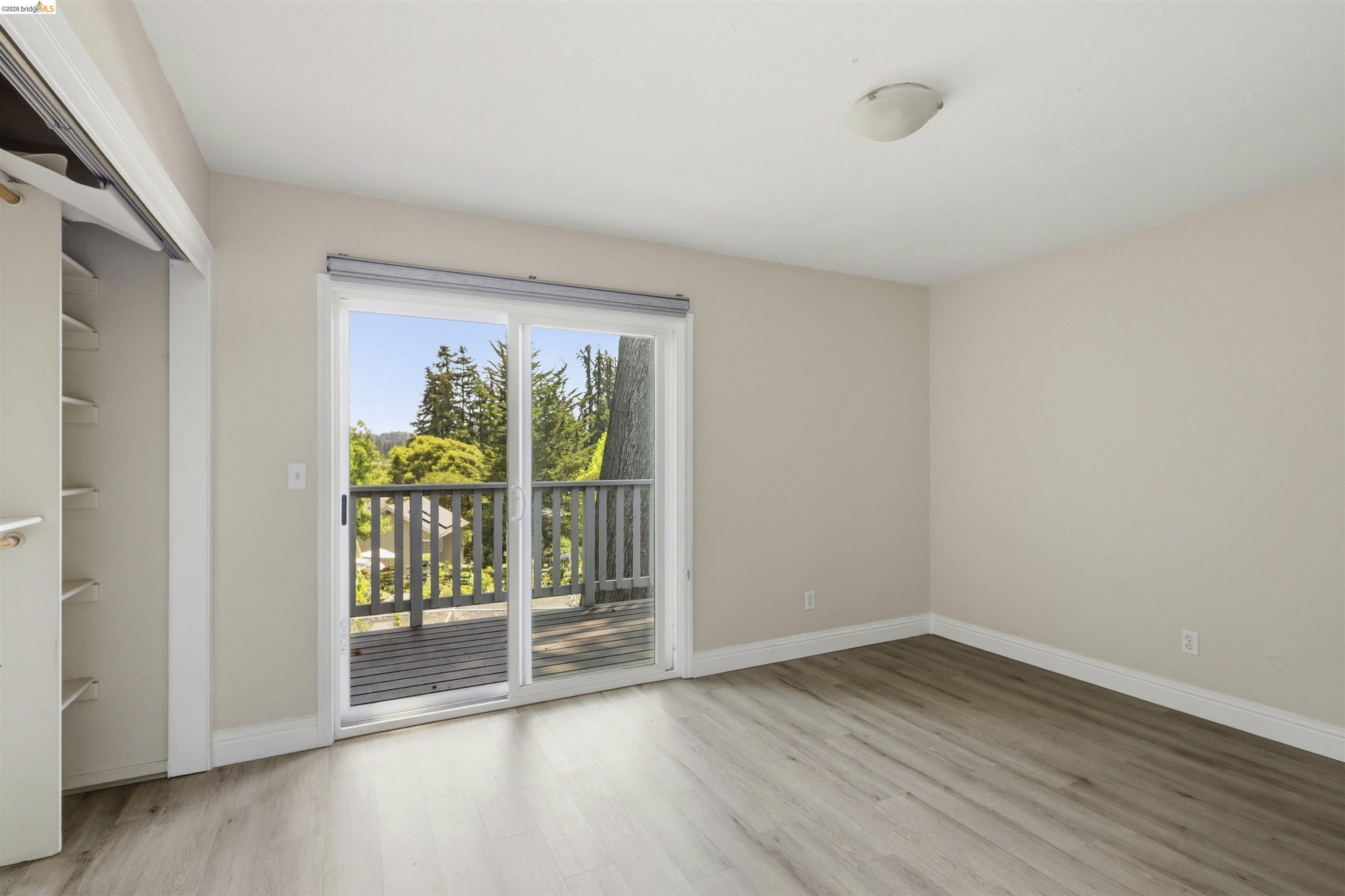 7555 Sunset Way, Unit 6 Aptos, CA 95003 - Photo 25 of 37 Room featuring wood-finish flooring, light-toned walls, and a ceiling-mounted light fixture
