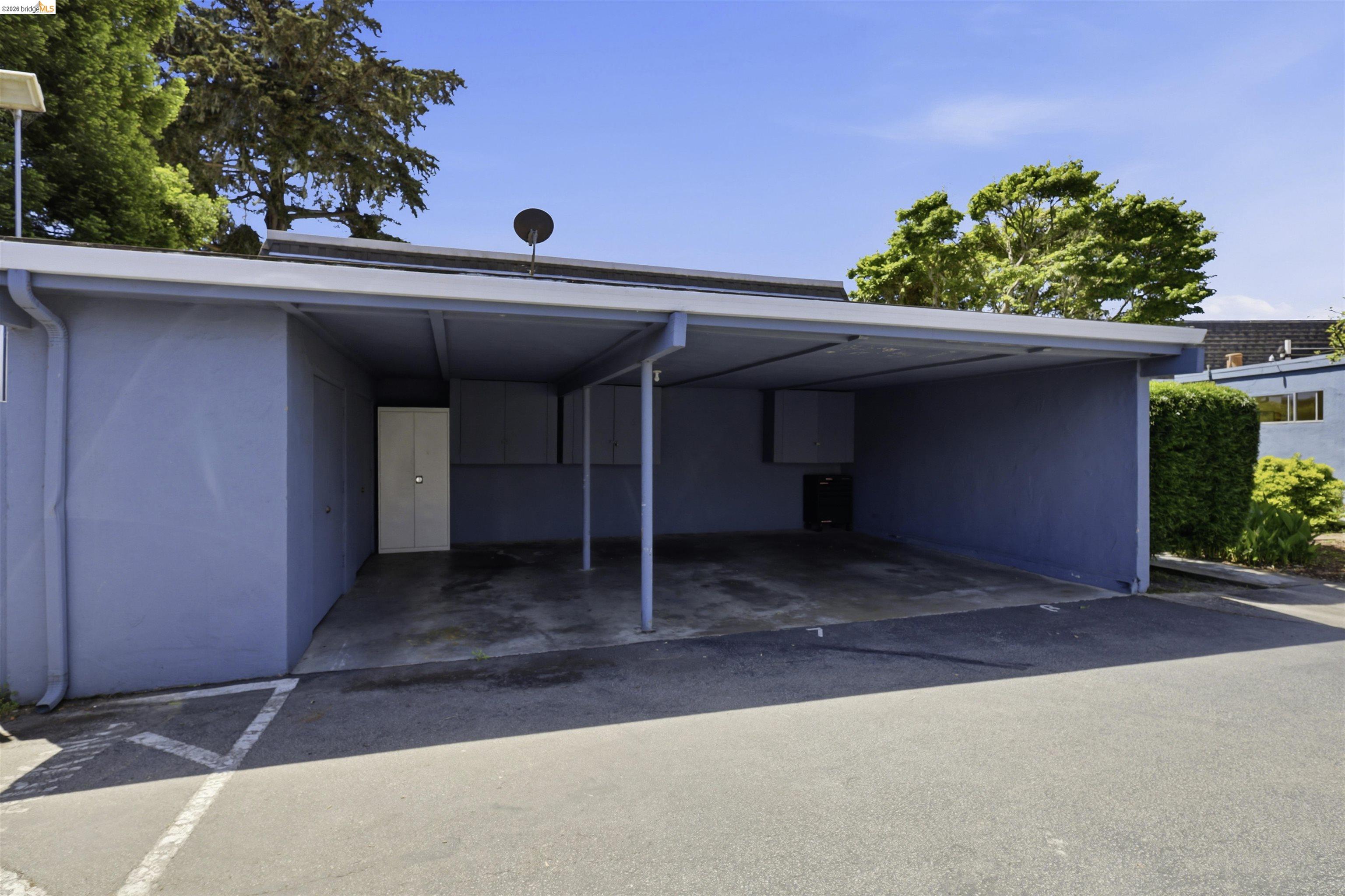 7555 Sunset Way, Unit 6 Aptos, CA 95003 - Photo 37 of 37 Covered carport providing sheltered parking, with an attached exterior storage unit featuring a white double door