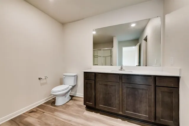 a bathroom with a sink vanity and a toilet