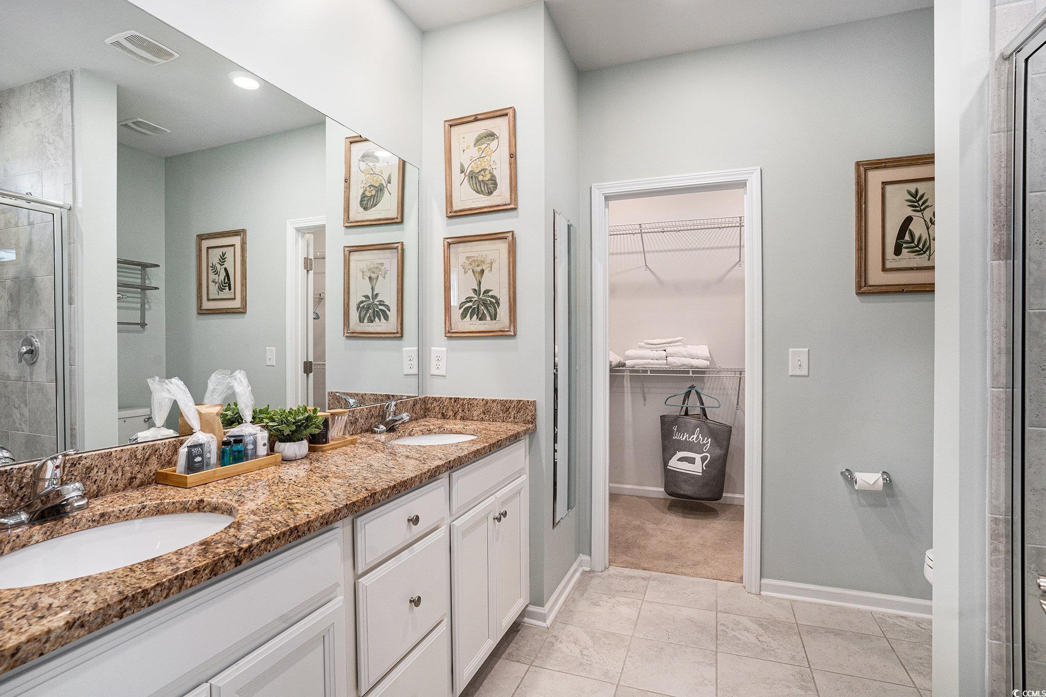 4754 Cloisters Lane Myrtle Beach, SC 29577 - Photo 14 of 32 Bathroom featuring a shower stall, double vanity, a walk in closet, light tile patterned floors, and recessed lighting