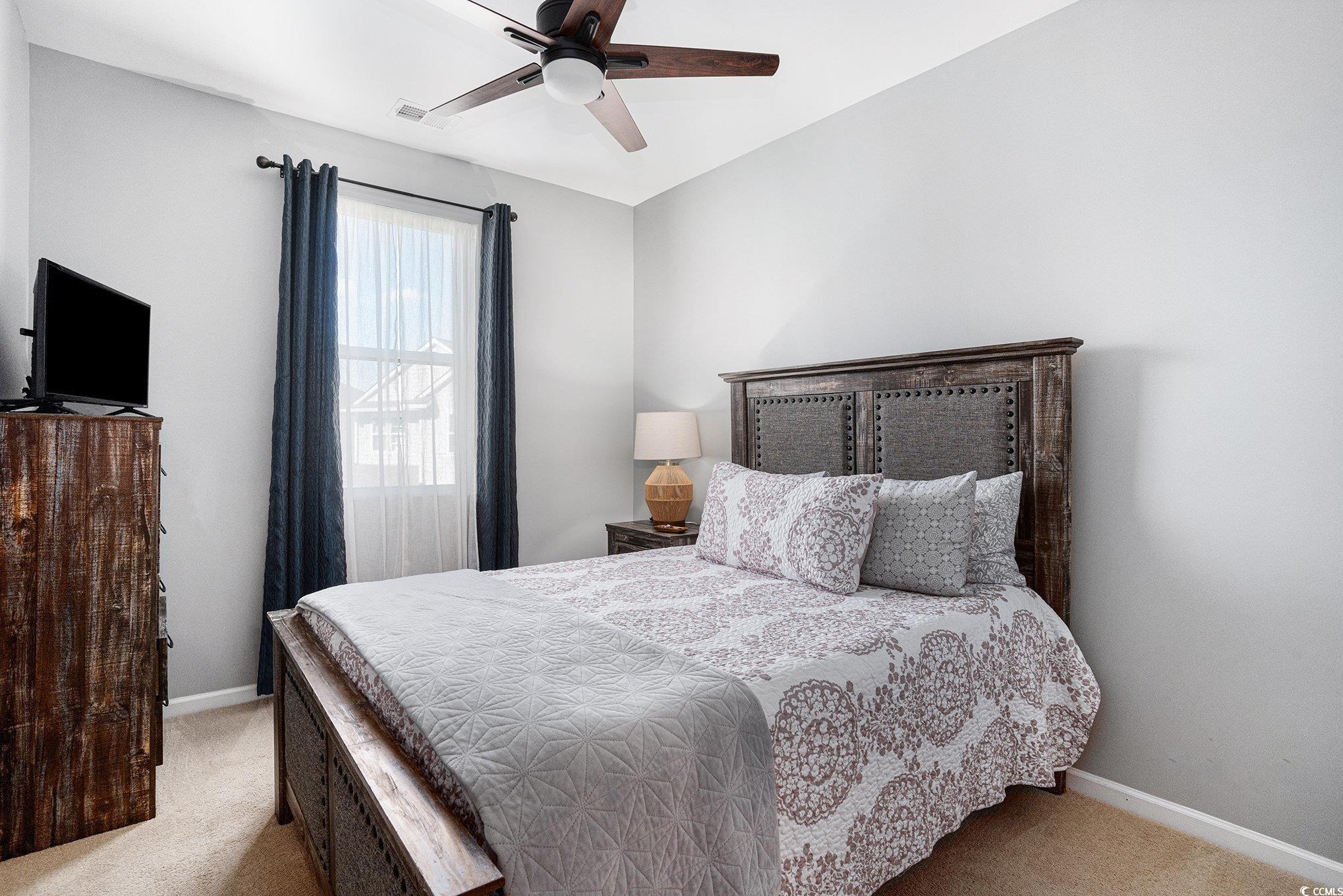 4754 Cloisters Lane Myrtle Beach, SC 29577 - Photo 16 of 32 Bedroom featuring light colored carpet and a ceiling fan
