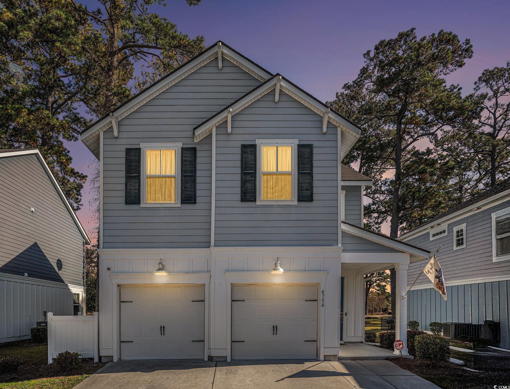 4754 Cloisters Lane Myrtle Beach, SC 29577 - Photo 2 of 32 View of front of property featuring a garage, concrete driveway, and board and batten siding