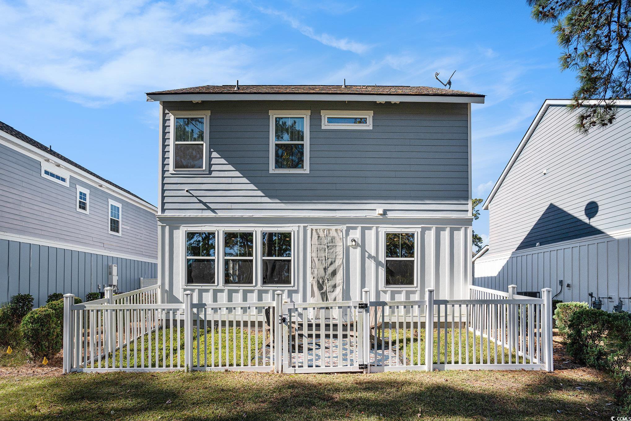 4754 Cloisters Lane Myrtle Beach, SC 29577 - Photo 24 of 32 Rear view of property with a fenced backyard and a gate