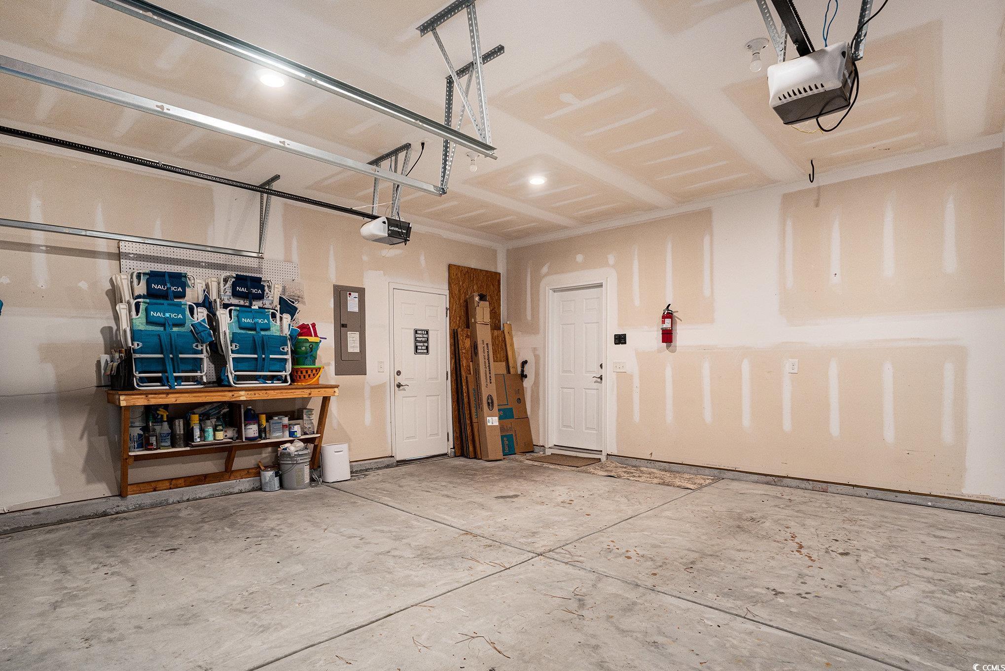 4754 Cloisters Lane Myrtle Beach, SC 29577 - Photo 26 of 32 Garage featuring electric panel and a garage door opener
