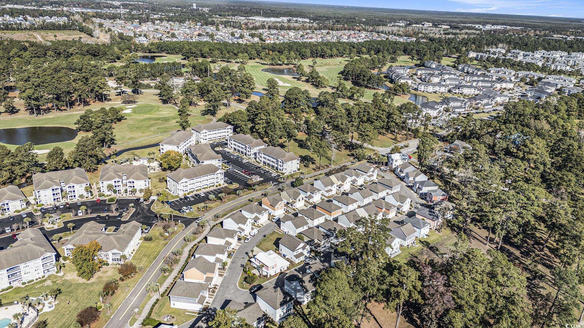 4754 Cloisters Lane Myrtle Beach, SC 29577 - Photo 29 of 32 Aerial view of property and surrounding area featuring nearby suburban area, a nearby body of water, and a local golf course