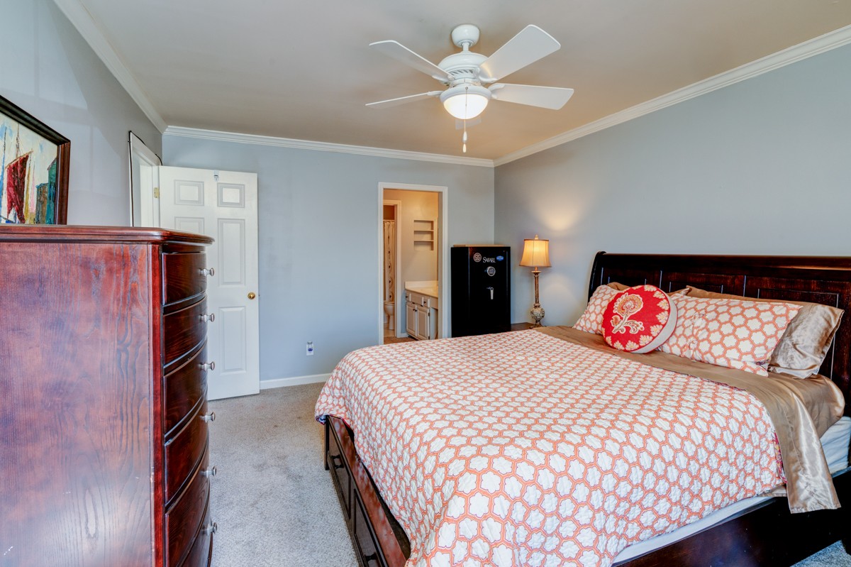 234 Pepper Ridge Circle Antioch, TN 37013 - Photo 15 of 28 a bedroom with a bed and a chandelier
