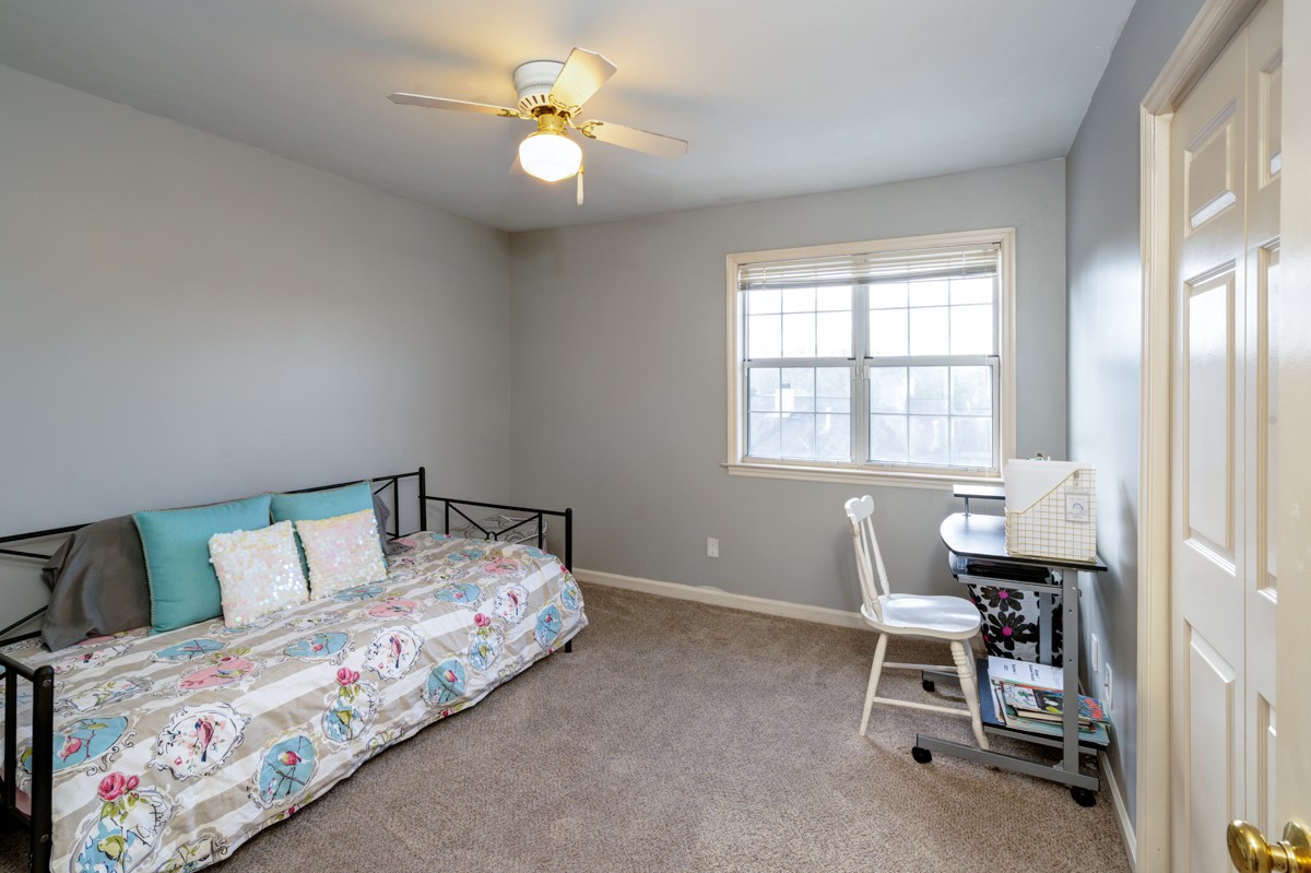 234 Pepper Ridge Circle Antioch, TN 37013 - Photo 20 of 28 a bedroom with a bed and a chair