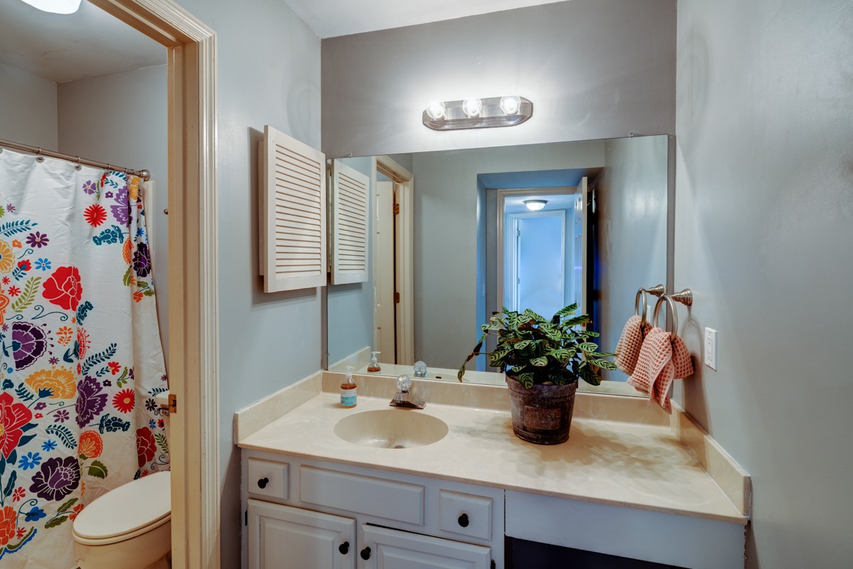 234 Pepper Ridge Circle Antioch, TN 37013 - Photo 25 of 28 a bathroom with a sink a toilet and a mirror