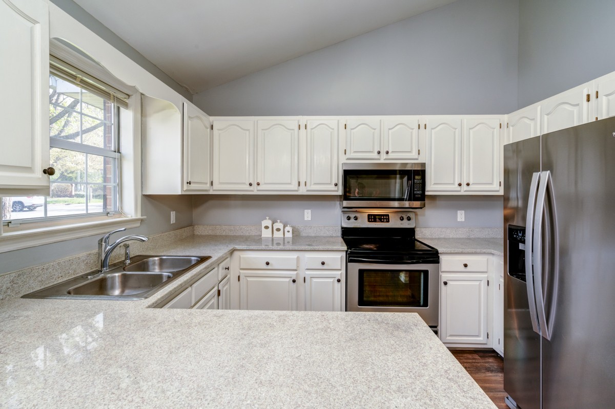 234 Pepper Ridge Circle Antioch, TN 37013 - Photo 5 of 28 a kitchen with white cabinets and stainless steel appliances