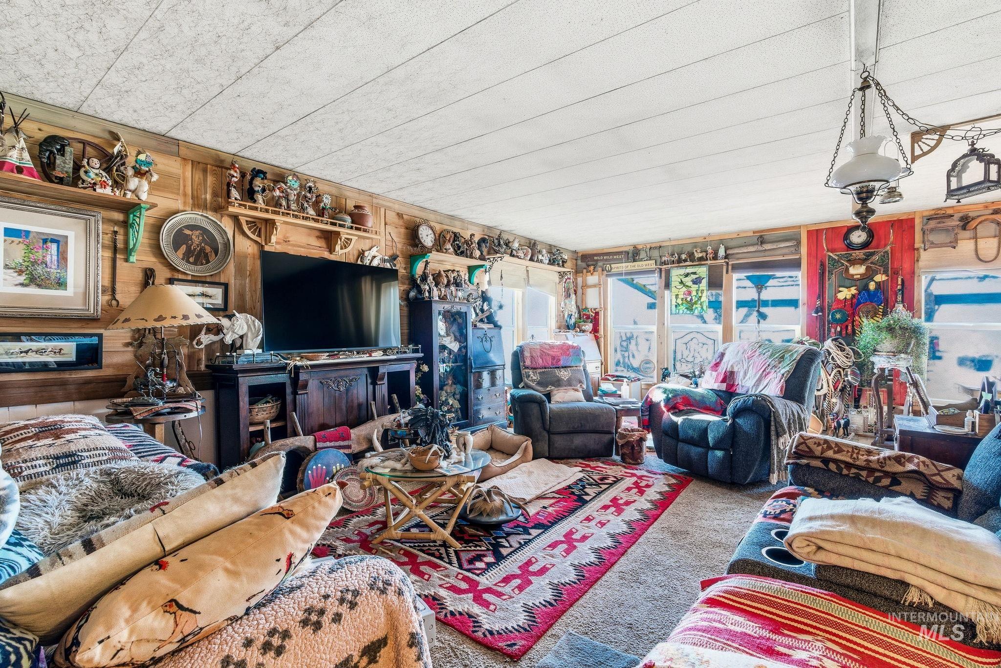 603 East King Road Kuna, ID 83634 - Photo 19 of 24 Living room featuring wood walls and carpet floors
