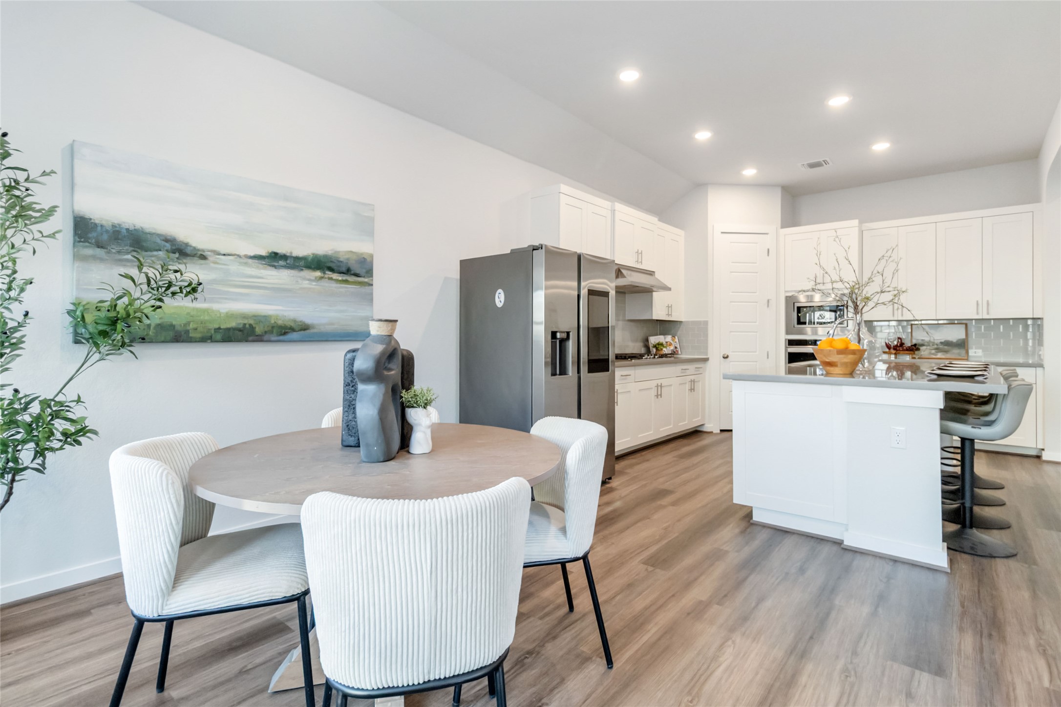 158 Sumter Way Kyle, TX 78640 - Photo 12 of 38 a kitchen with stainless steel appliances a dining table chairs refrigerator and sink