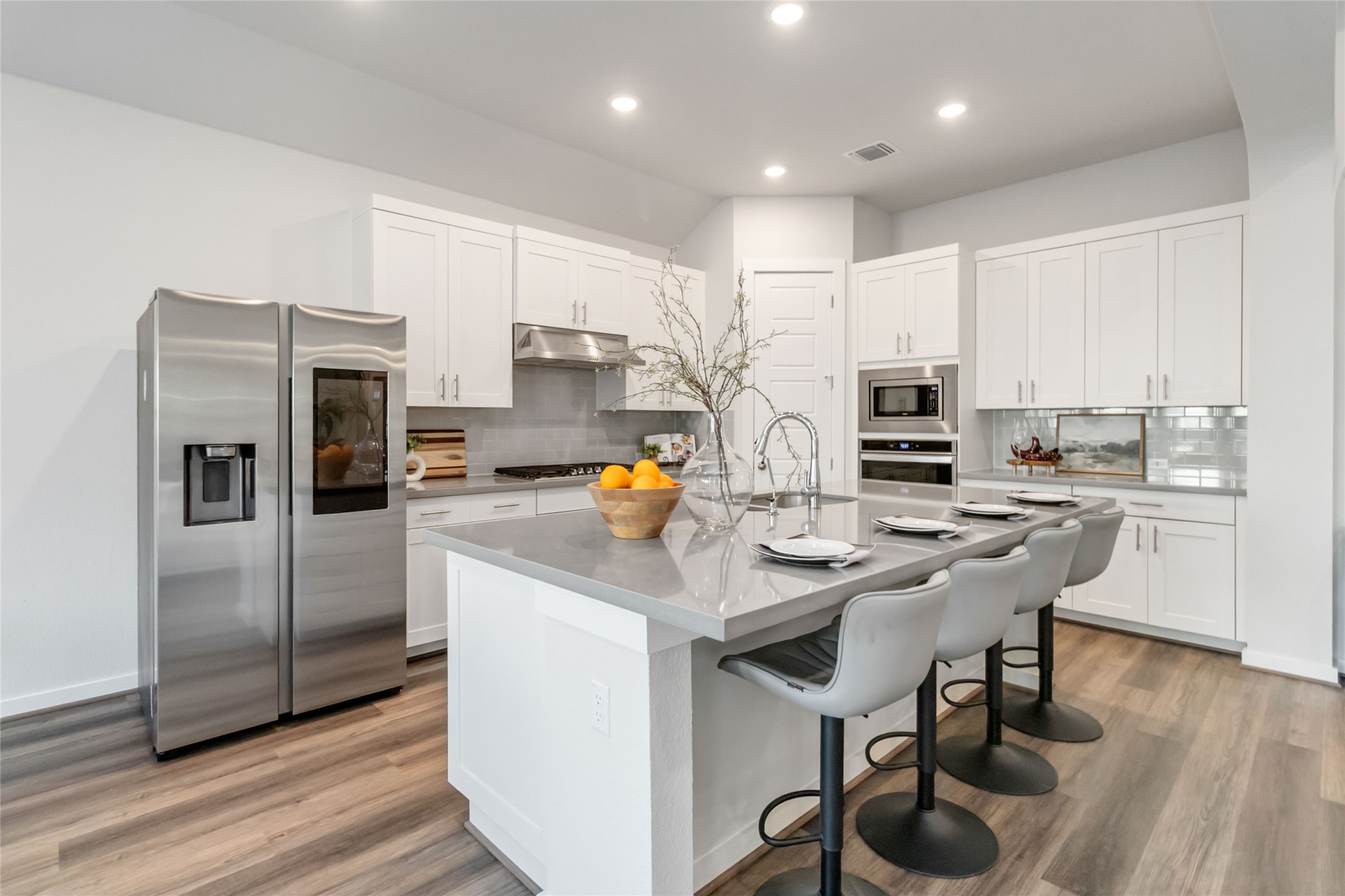 158 Sumter Way Kyle, TX 78640 - Photo 13 of 38 a kitchen with stainless steel appliances a refrigerator a stove a sink a dining table and chairs