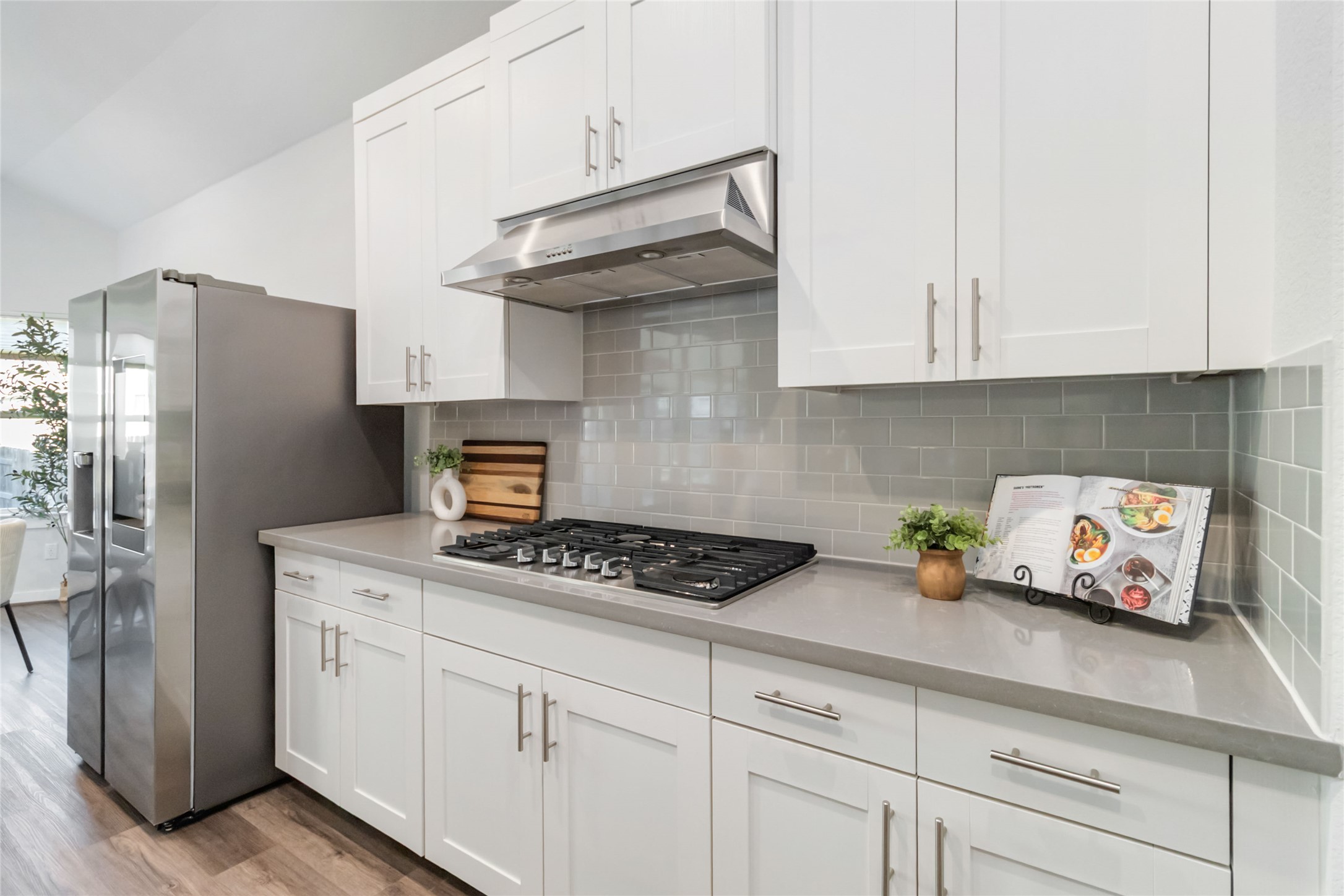 158 Sumter Way Kyle, TX 78640 - Photo 14 of 38 a kitchen with stainless steel appliances granite countertop a refrigerator a stove a sink and white cabinets