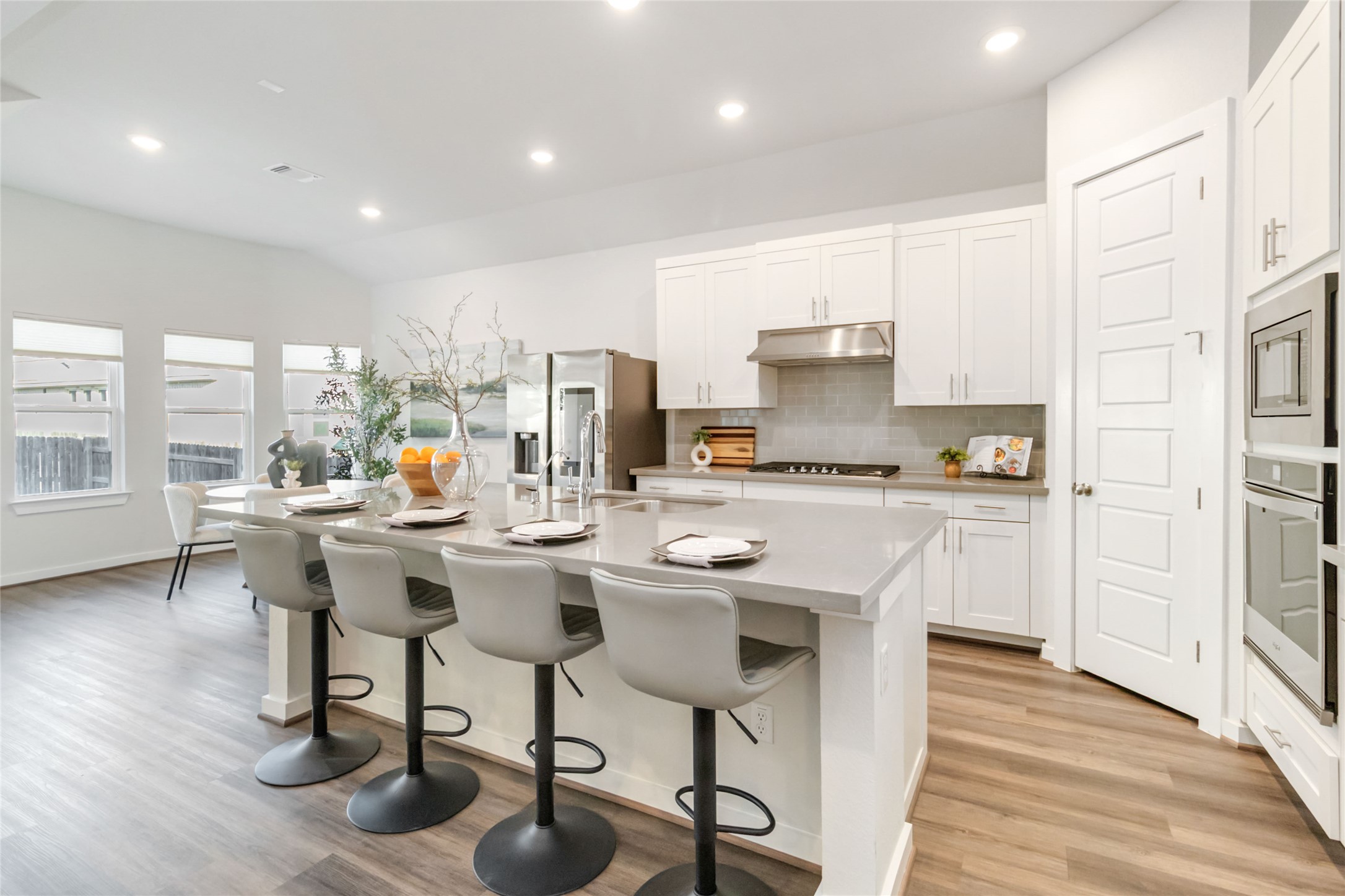 158 Sumter Way Kyle, TX 78640 - Photo 15 of 38 a kitchen with a dining table chairs refrigerator and cabinets
