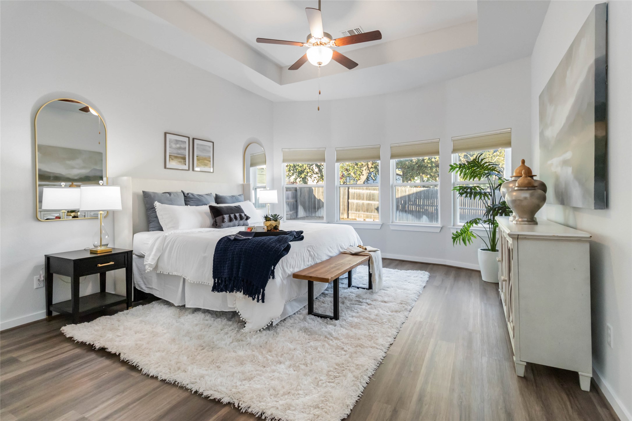 158 Sumter Way Kyle, TX 78640 - Photo 28 of 38 a bedroom with a bed wooden floor and a large window