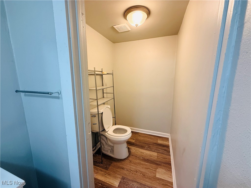 5239 Arch Street Maple Heights, OH 44137 - Photo 17 of 25 Bathroom featuring dark wood-style floors and toilet