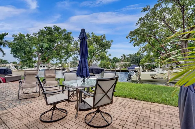 a view of a patio with table and chairs and potted plants