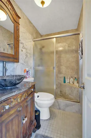 a en suite bathroom with a double vanity sink a mirror and shower