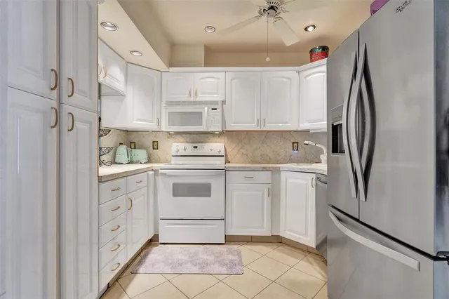 a view of a dining room with furniture a livingroom and chandelier