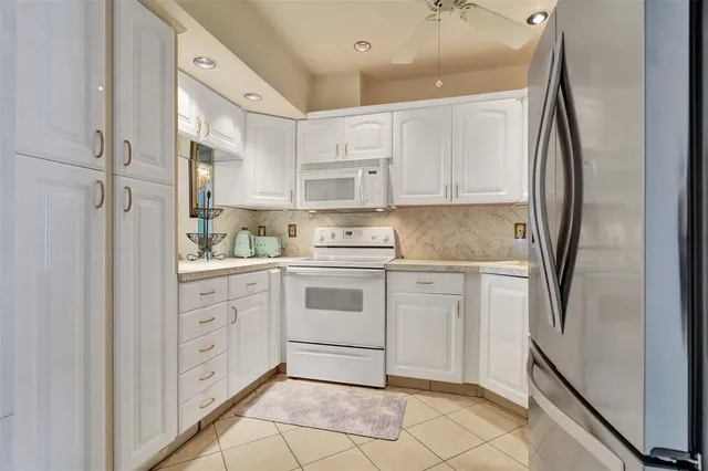 a kitchen with stainless steel appliances kitchen island granite countertop a sink and cabinets