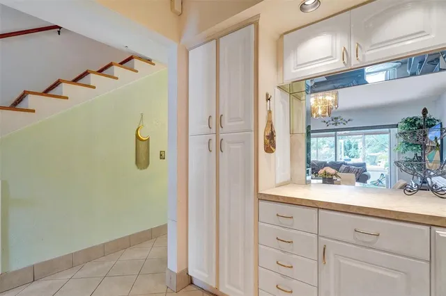 a view of a dining room with furniture a chandelier and wooden floor