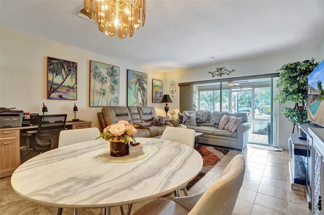 a living room with patio furniture and a floor to ceiling window