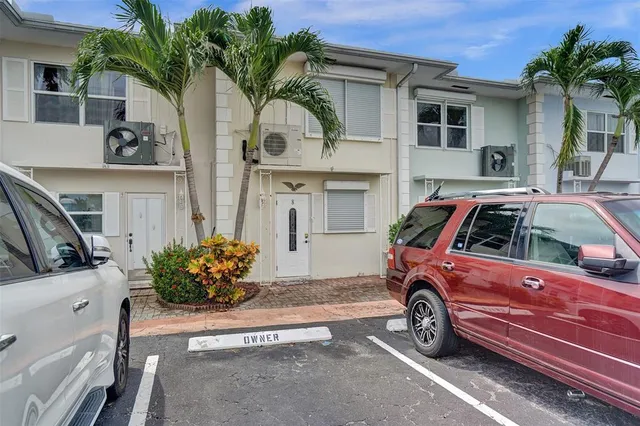a view of a car parked front of a house
