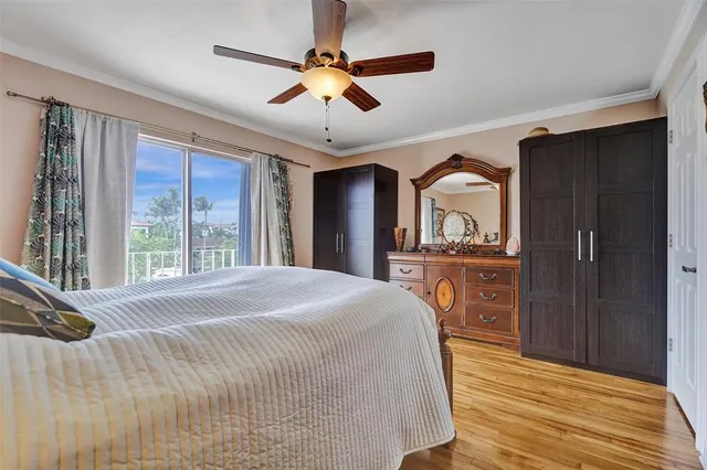 a bedroom with a bed dresser and a large window
