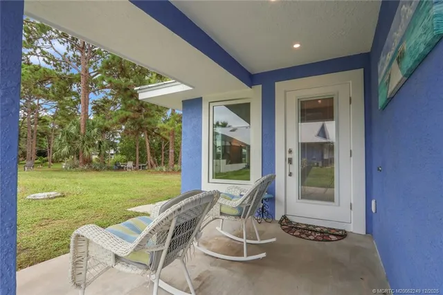 a living room with patio furniture and a flat screen tv