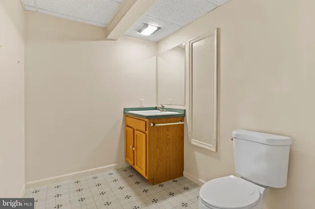 a bathroom with a toilet and a mirror