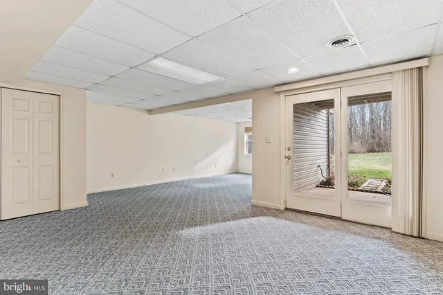an empty room with an entrance to ceiling window