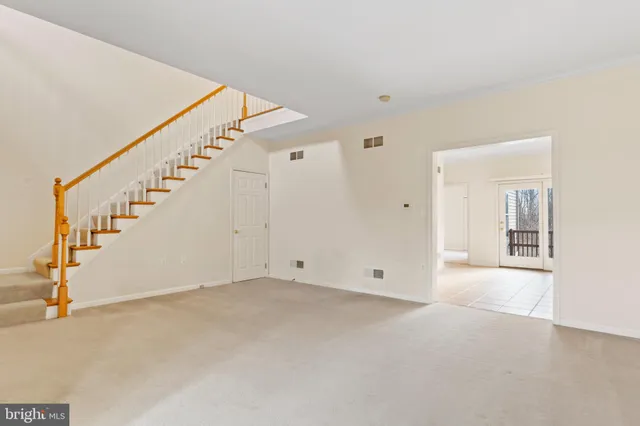 a view of an empty room with stairs