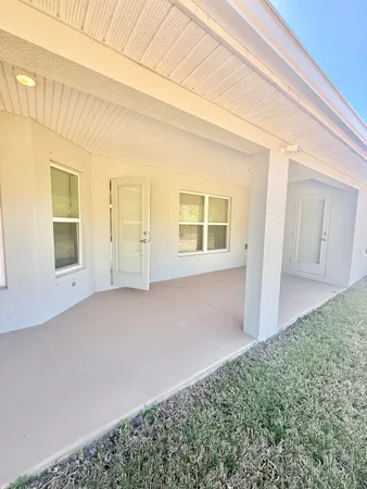 a view of a swimming pool with a table and chairs under an umbrella