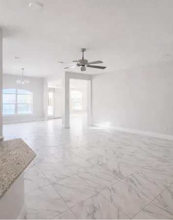 a view of a kitchen with granite countertop a sink and a stove