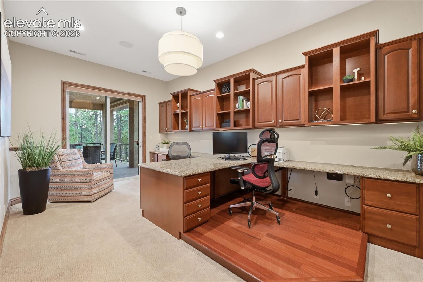 4865 Hidden Rock Road Colorado Springs, CO 80908 - Photo 16 of 50 Main level office with two builtin desks, walk out to deck and walk in closet!