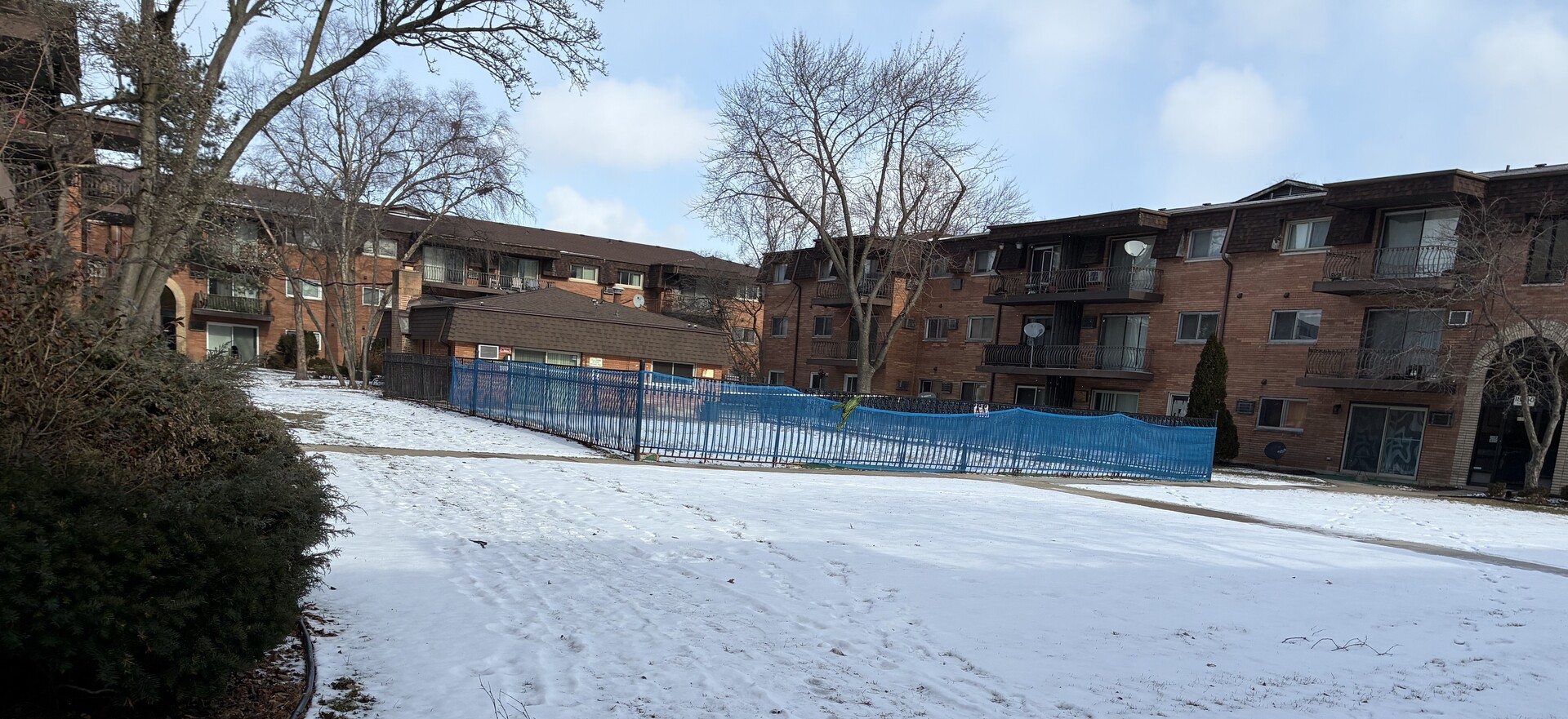 2340 186th Street, Unit 7 Lansing, IL 60438 - Photo 14 of 14 a view of a house with a yard covered with snow