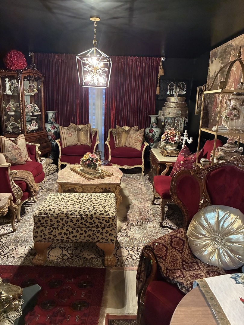 2340 186th Street, Unit 7 Lansing, IL 60438 - Photo 9 of 14 a living room with furniture a chandelier and a fireplace