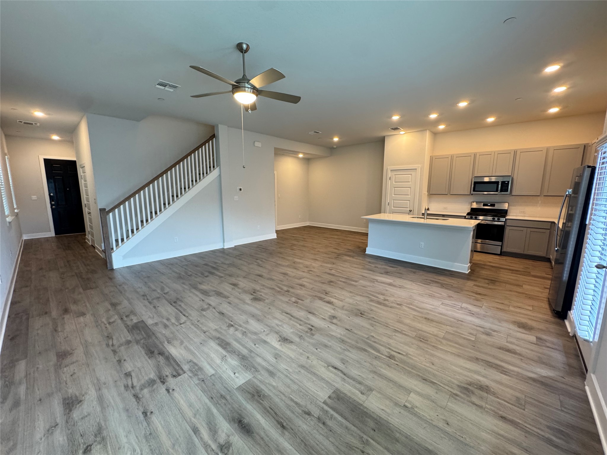 3000 Chisholm Trail Road, Unit 20 Round Rock, TX 78681 - Photo 2 of 26 An open-concept living space presents a well-appointed kitchen, a functional kitchen island, and a prominent staircase.