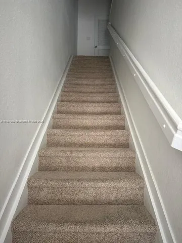 a kitchen with stainless steel appliances granite countertop a sink a stove a microwave and cabinets